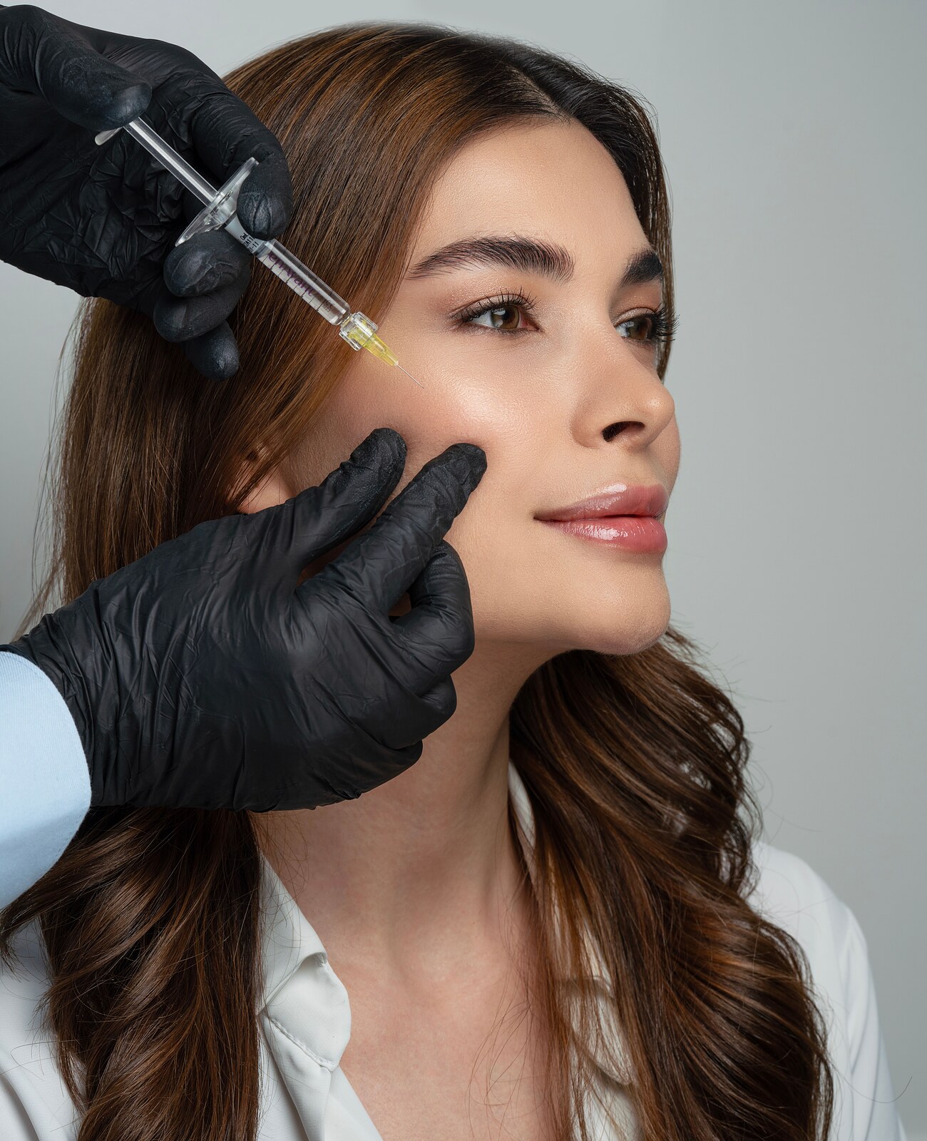 A syringe prepared in black gloves